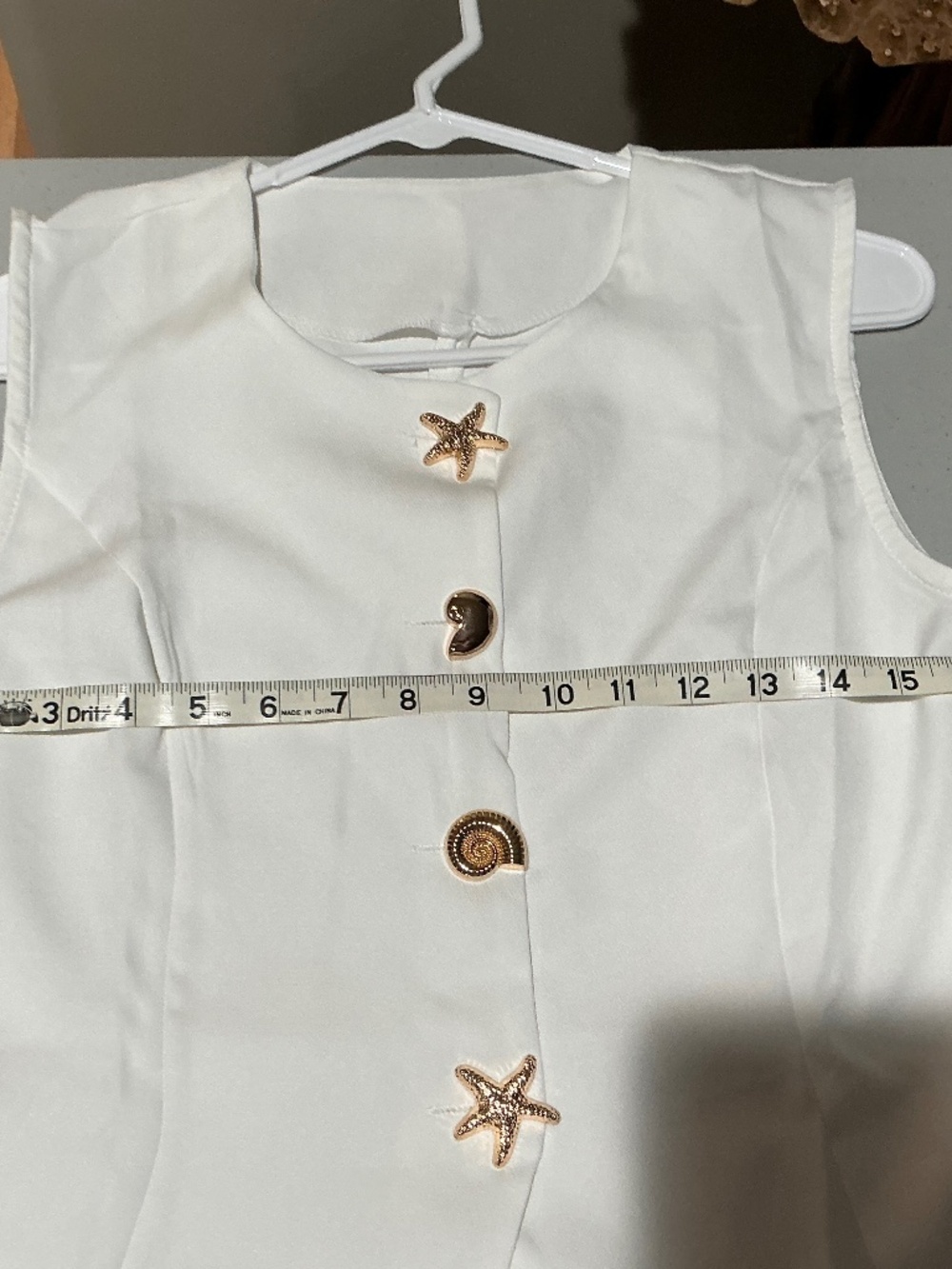White boutique vest with seashell buttons